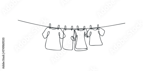 Four T-shirts hanging on a clothesline