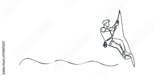 Man rock climbing cliff face with rope