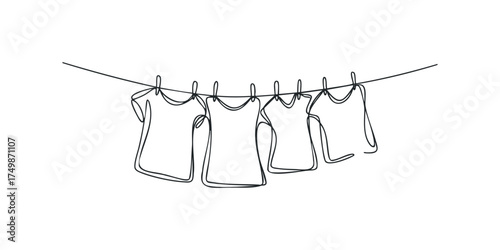 Four T-shirts drying on a clothesline