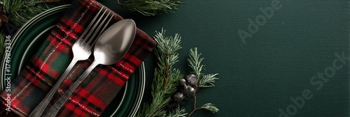 Festive Holiday Table Setting With Green Plate and Plaid Napkin on Dark Green...