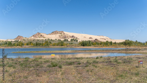Fototapeta Naklejka Na Ścianę i Meble -  Yulong Sand Lake — Serenity among Desert and Water