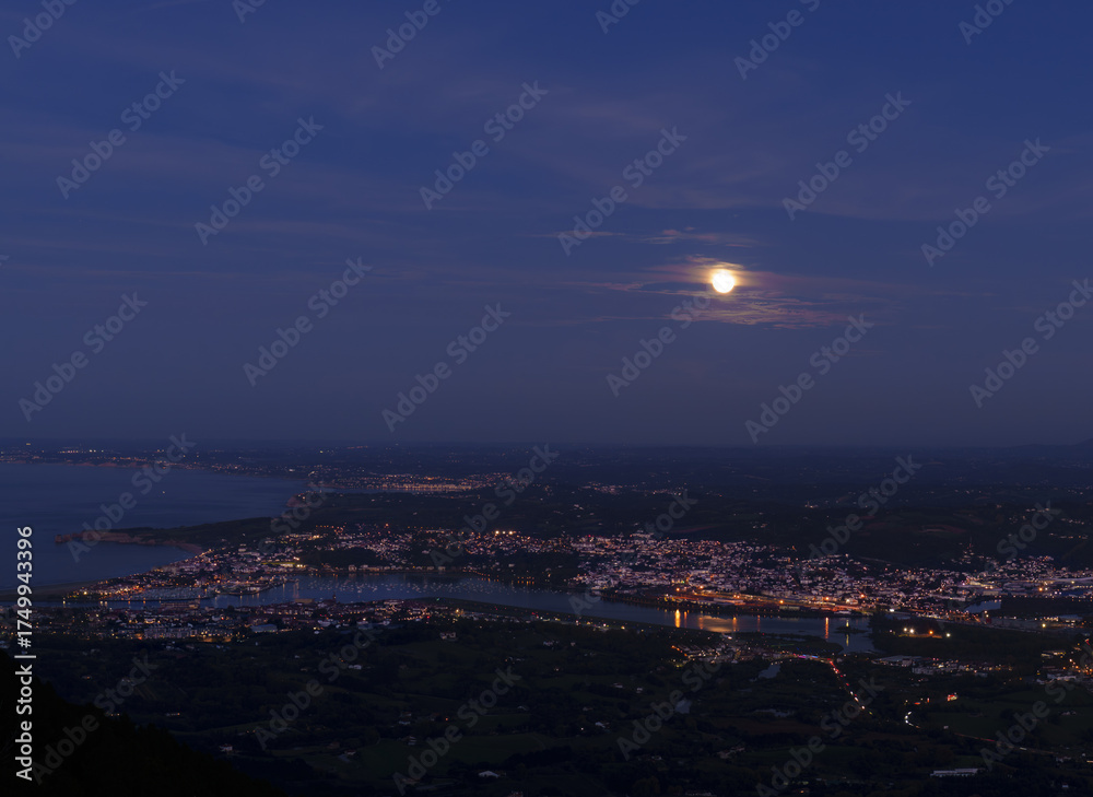 Fototapeta premium Full moon over Hondarribia and Hendaye, Basque Country