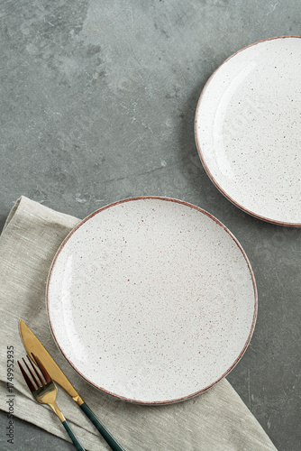 White dinner plates for main courses on a gray background