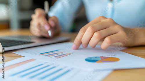 Wallpaper Mural Analyzing financial data and charts. Businesswoman reviewing reports with bar graphs, pie charts, and figures.  Working on laptop in the office. Torontodigital.ca