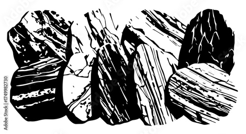Group of Black and White Stone Rocks with Striated Textures and Unique Shapes.