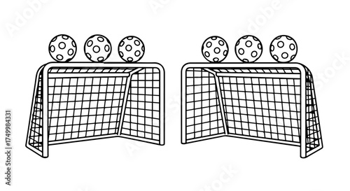 Two miniature portable goal nets with soccer balls on top in a playful outdoor sports setup.