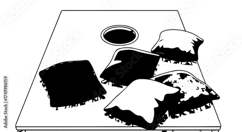 Black and White Cornhole Board with Scattered Bean Bags, Outdoor Game.