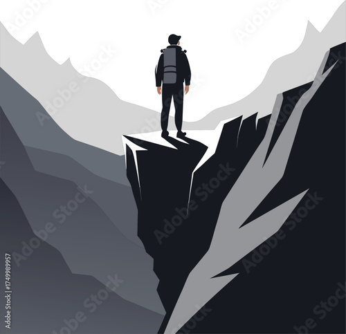 Lone hiker stands on cliff edge overlooking mountain valley