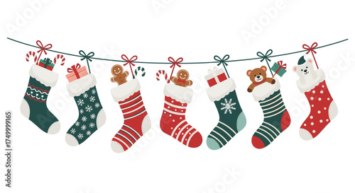 A festive collection of christmas stockings filled with holiday treats and toys hanging on a decorated string.