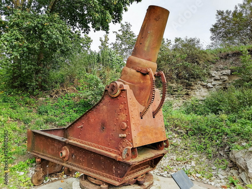 An old, rusty cannon with a large metal barrel.