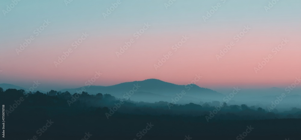 Fototapeta premium Misty mountains at dawn under a pastel sky