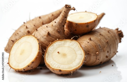 Raw wild yam root lies on a white surface. Sliced fresh root vegetable is ready for consumption. Earthy tuber boasts natural texture. This edible plant symbolizes wellness and alternative medicine.