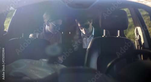 Corporate meeting of two employees in car for work and discussion of business