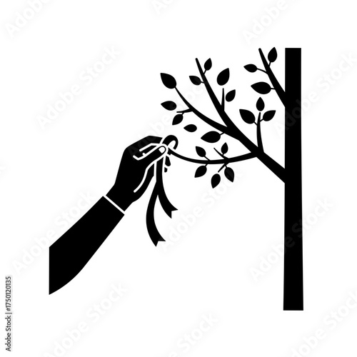 Hand tying ribbon to tree icon in black for memorial or support theme
