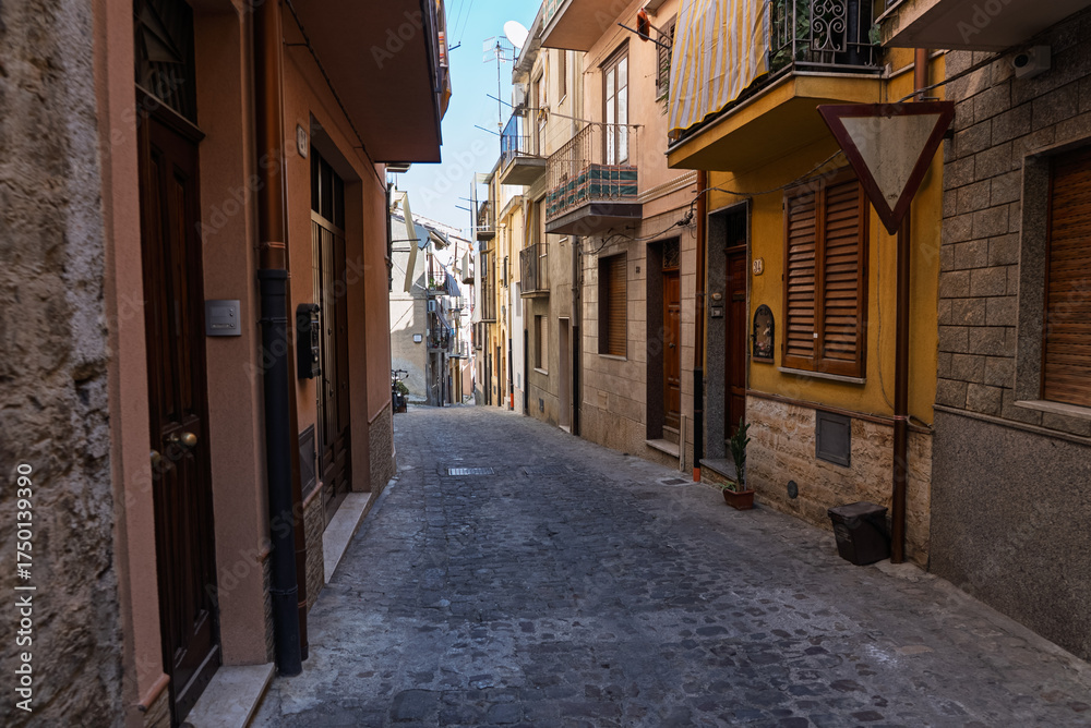 Fototapeta premium Castelbuono medieval town in the Madonie Mountains, Sicily, Italy, basking under the summer sun with historic streets, Ventimiglia Castle. Old mountain town in Sicily. Italian town in hills