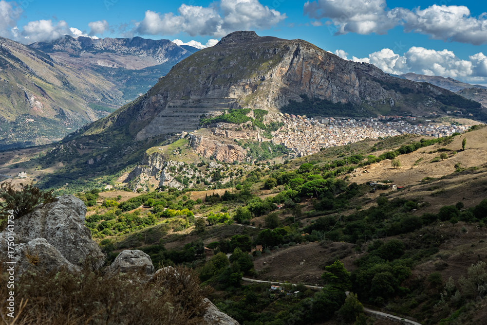 Obraz premium Caltavuturo, a historic Sicilian mountain town in the Madonie Mountains, featuring its medieval castle, charming narrow streets, and traditional stone houses, Sicily, Italy. Italian town in hills