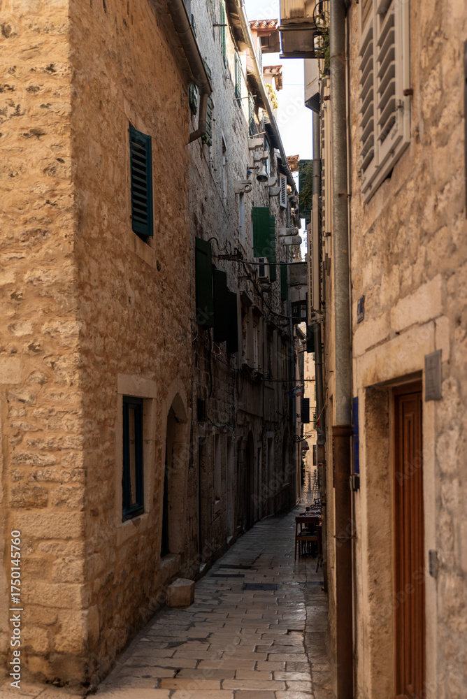 Fototapeta premium Charming narrow street in a historic stone town