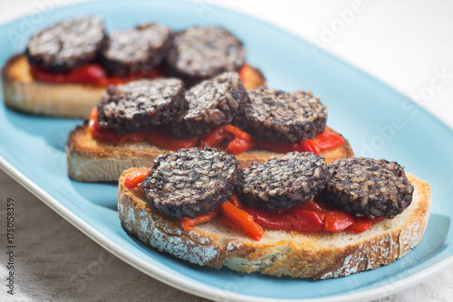 Tapa of Burgos blood sausage with peppers on a tray