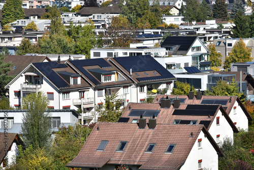 Houses with solar panels on the roofs in a residential area.