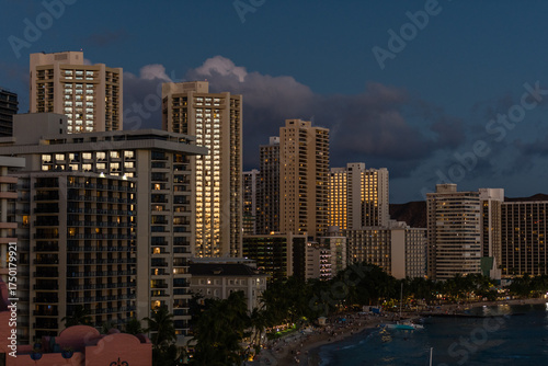 Scenic aerial Waikiki Beach vista at sunset with sun reflecting in the skyscrapers' windows, Honolulu, Oahu, Hawaii