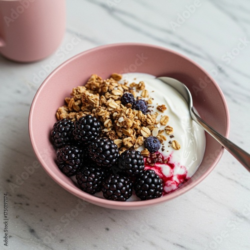 A vibrant breakfast bowl featuring fresh blackberries, granola, and creamy yogurt, bathed in soft morning light for a healthy start ,summer ,natural ,superfood