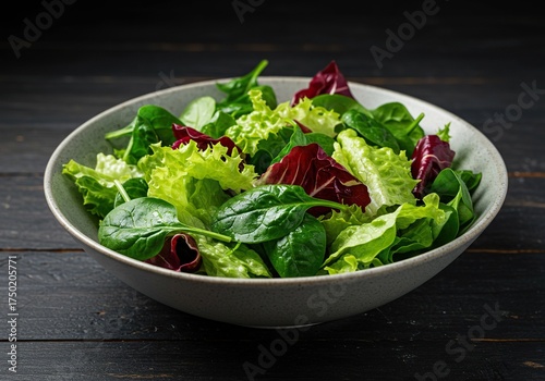 A vibrant, fresh greens salad with crisp lettuce, spinach, and mixed greens, artfully arranged in a bowl, perfect for healthy dining ,bowl ,fitness ,dinner