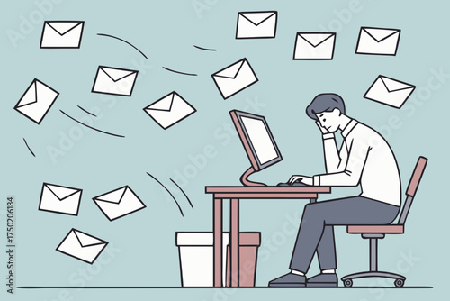 An overwhelmed office worker sits at his desk