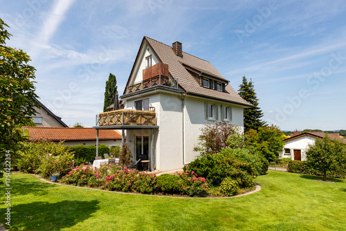 Wallpaper Mural typical german one family house with garden, grass and flowers Torontodigital.ca