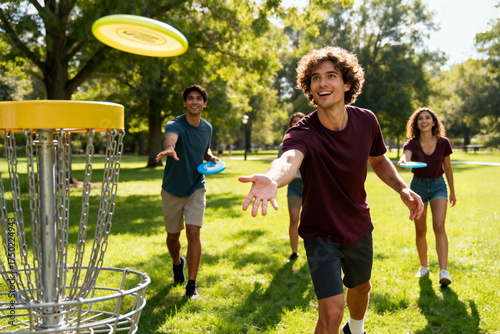 Group of friends playing disc golf in park on a sunny day.