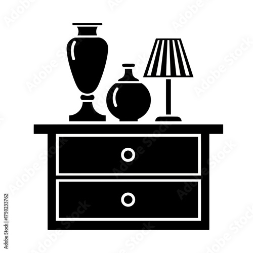 A black and white illustration of a nightstand with two drawers, a lamp, and two vases, isolated on a