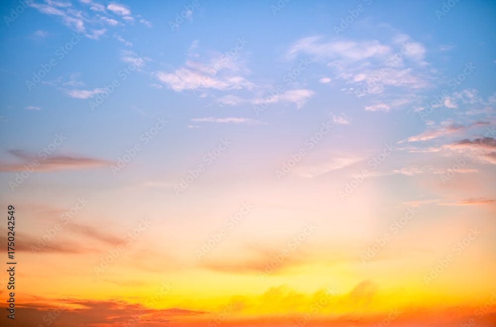 Naklejka premium Sunset or sunrise sky with a vibrant gradient of orange, gold, and soft blue. Clear atmosphere with wispy clouds. Peaceful, natural light background. hope, freedom, new day and inspirational Concepts