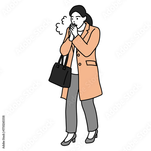 冬の通勤　手を温めるコート姿の女性