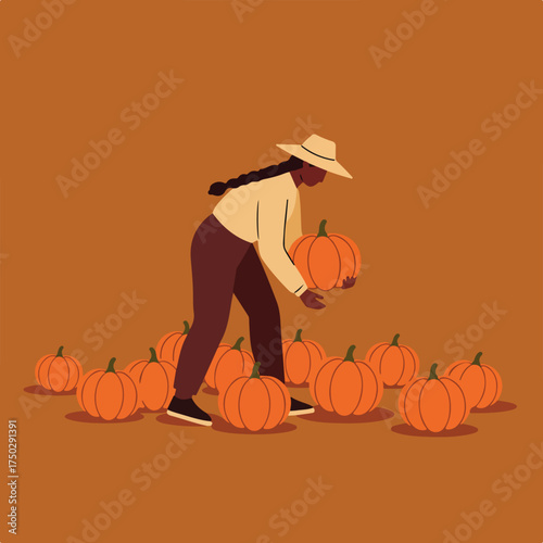 Person in hat collecting pumpkins in field