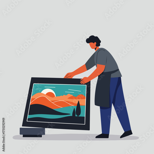 Person handling a framed artwork with a sunset landscape