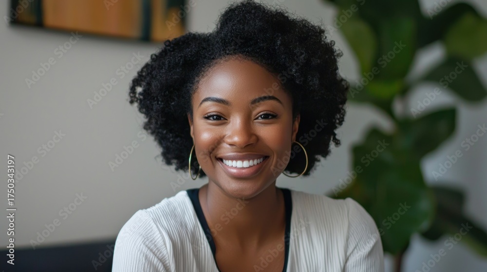 Fototapeta premium A woman smiling and speaking into a webcam, leading an online business meeting