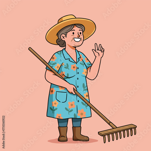 Smiling older woman in straw hat, blue floral dress, dark leggings, and brown boots holding a rake, making an "OK" gesture, standing against a light pink background.