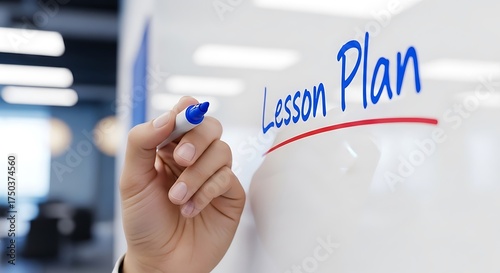 Teacher writing lesson plan on a whiteboard with blue marker