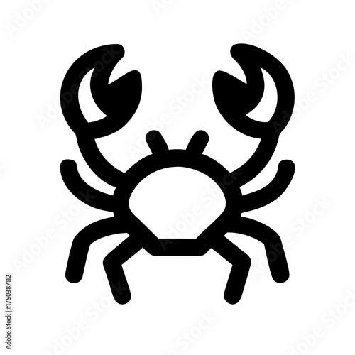 A close up shot of a black and white cat with striking green eyes looking directly at the camera with a soft focus background