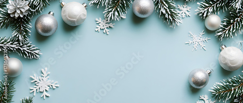 Christmas background with white and silver decorations on a light blue surface, a flat lay composition, top view.