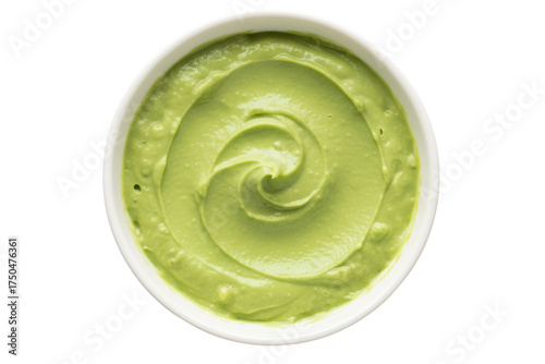 Top view of a round white bowl with smooth green guacamole sauce isolated on a transparent background