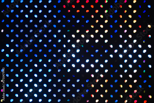 Close-up background of a vibrant LED light panel, displaying a grid of small, glowing dots in various colors.