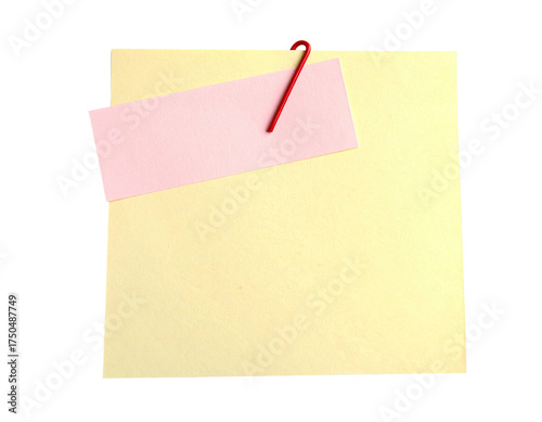 A pale yellow sticky note with a pink rectangle attached by a red paper clip