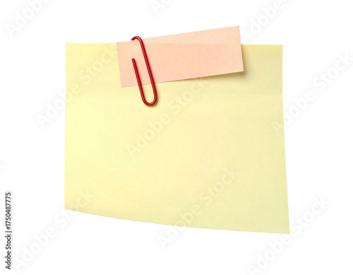 Yellow sticky note with pink note clipped on; isolated on a black background