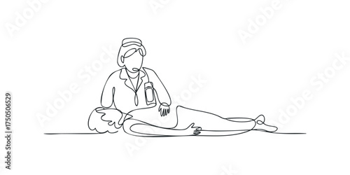 Medic assisting injured person lying on the ground