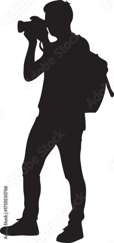 Silhouette of a photographer with a backpack taking a picture