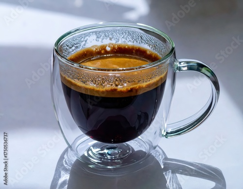 Espresso coffee in double wall glass cup with crema
