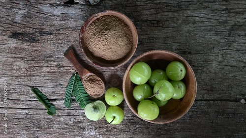Fresh Amla (Indian gooseberry, Phyllanthus emblica) fruits with leaf on wooden background. herbal medicine plant