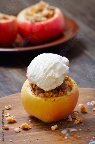 Baked apples stuffed with nut and honey served with ice cream