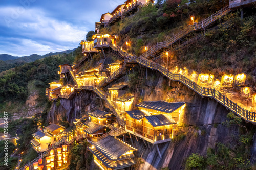Scenic Cliffside Resort with Illuminated Buildings at Dusk