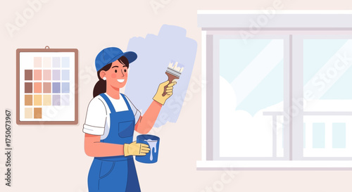 Cheerful woman painting a wall in a room, renovating her home with new colors